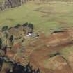 Oblique aerial view of the southern terminal of the Loch Doon Gunnery School railway,  cutting across the field and ending at a small loading platform by the Gaw Glen Burn, looking NNW.