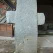 View of cruciform stone situated inside church.