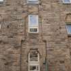 Detail of first, second and third floor windows at Working Men's Home, 70-76 Grove Street, Edinburgh.