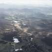 General oblique aerial view across Nuide Moss towards Phoines and Etteridge, with the Dunkeld to Inverness Military Road crossing Milton Burn at Drochaid Balbh Bhardain, looking SW.