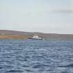 View of inter-island ferry Hoy Head leaving Flotta, from SW