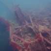 View of rock ballast, steel piping and hull plating on steamship Numidian