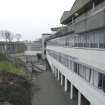 Elevated view along east facade of main block from north.