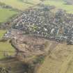 Oblique aerial view of the housing estate under construction at the NE end of Biggar, looking SE.