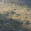 Oblique aerial view of Leadhills village, the mining remains and the field systems, looking WSW.