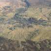 General oblique aerial view of Leadhills village, the mining remains and the golf course, looking E.