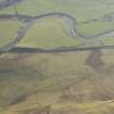 Oblique aerial view of thetrain on the West Coast Main line at Crawford and the site of the cairn, looking S.