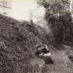 View of pathway with two ladies sitting on a bank below St Germains House.