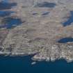 General oblique aerial view of Dun Dulorichan with Loch Airigh Raonuill beyond on the Isle of Coll, looking WNW.