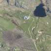 Oblique aerial view of Ballyhaugh Cottage centre on the Isle of Coll, looking NE.