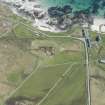 Oblique aerial view of Hynish Lighthouse shore establishment, reservoir  and harbour on Tiree, looking NE.