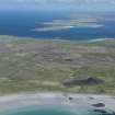 General oblique aerial view of Tiree with Gunna and Coll beyond, looking NE.