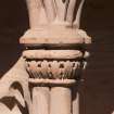 Gallery, arched stone seat, detail of carved capital