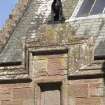 Entrance to north west courtyard, detail of stone panel with hound above