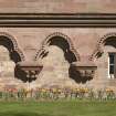 Gallery, detail of trilple arches and carved capitals at ground level