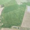 Oblique aerial view of the cropmarks of the linear features, possible quarry and rectilinear enclosure at Troustrie, looking E.