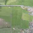 Oblique aerial view of the grassmarks of the ring ditch at Gilliesfaulds, looking S.