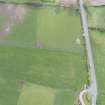 Oblique aerial view of the grassmarks of the ring ditch at Gilliesfaulds, looking W.