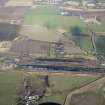 Oblique aerial view of Thornton Marshalling Yard and Corsbie Hall House, looking N.