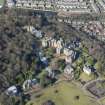 Oblique aerial view of New Craig House, Queen's Craig House, East Craig House, Bevan House, South Craig House, The New Learning Resource Centre and Old Craig House, looking NW.
