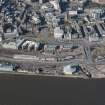 Oblique aerial view of Tay Bridge Railway Station, Discovery Point and Dundee Old Harbour, looking NW.