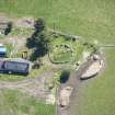 Oblique aerial view of Cairn Irenan chambered cairn, looking SE.