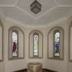 Baptistry. Font and five stained glass windows.