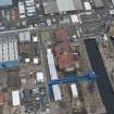 Oblique aerial view of Rosyth Naval Dockyard showing the construction of an aircraft carrier, looking NE.