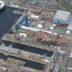 Oblique aerial view of Rosyth Naval Dockyard showing the construction of an aircraft carrier, looking W.