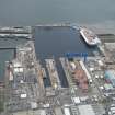 Oblique aerial view of Rosyth Naval Dockyard showing the construction of two aircraft carriers, looking SW.