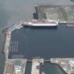 Oblique aerial view of the Main Basin, Rosyth Naval Dockyard showing the construction of an aircraft carrier, looking W.
