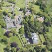 Oblique aerial view of Mortonhall House, terraced garden, stable court and granary, looking E.