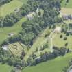 Oblique aerial view of Ballindalloch Castle, walled garden and stables, looking SE.