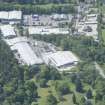 Oblique aerial view of Aberlour House West Lodge and the adjacent industrial estate, looking WNW.