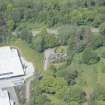 Oblique aerial view of Aberlour House West Lodge, looking NNW.