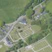 Oblique aerial view of Mortlach Parish Church, burial gounds and watch house, looking NW.