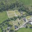 Oblique aerial view of Mortlach Parish Church, burial gounds and watch house, looking SE.