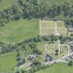 Oblique aerial view of Mortlach Parish Church, burial gounds and watch house, looking E.