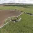 Oblique aerial view of the broch near Manse of Harray, looking SE.