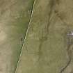 Oblique aerial view of the farmstead and cairns overlain by a modern dyke, at Knapknowes, looking ESE.