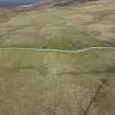 Oblique aerial view of the farmstead and cairns overlain by a modern dyke, at Knapknowes, looking NE.