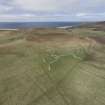 Oblique aerial view of the farmstead and later enclosures at Mid Quandale, looking NW.