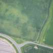 Oblique aerial view of the cropmarks of the rectilinear settlement, looking ENE.