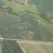 Oblique aerial view of the cropmarks of the barrow, unenclosed settlement and pits, looking NNE.