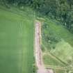 Oblique aerial view of the cropmarks of the fort during the Glasgow University excavation, looking SSE.