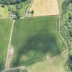 Oblique aerial view of the cropmarks of the rectilinear settlement, looking ESE.