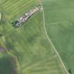 Oblique aerial view of the cropmarks of the ring ditch house and the pits, looking SW.