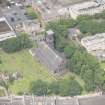 Oblique aerial view of Trinity House and South Leith Parish Church and Churchyard, looking NW.