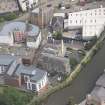 Oblique aerial view of Quayside Mills, looking E.