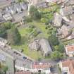 Oblique aerial view of St Triduana's Chapel, Restalrig Parish Church and Churchyard, looking W.
